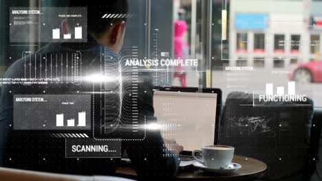 animation of interface with data processing over rear view of businessman using laptop at a cafe