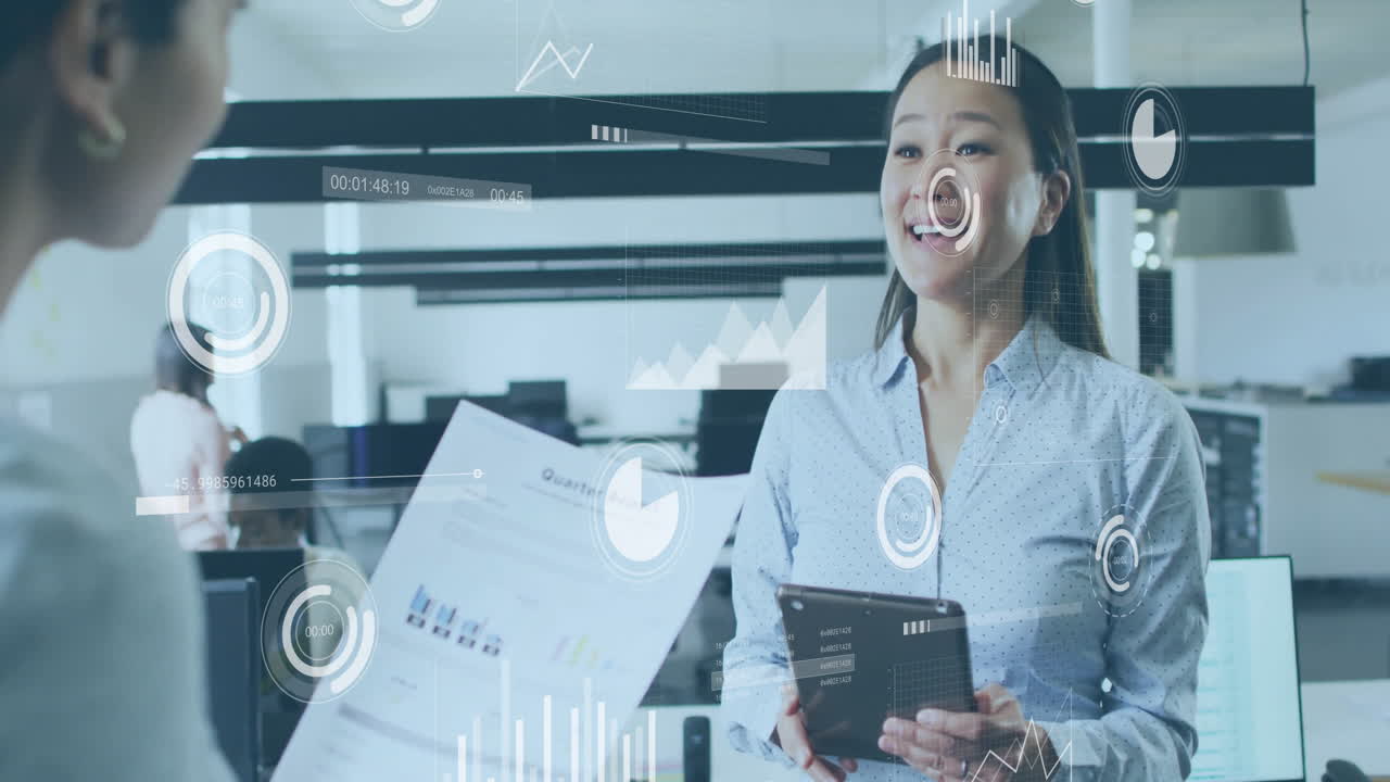 Using animation, businesswoman discussing data with colleague on tablet in office