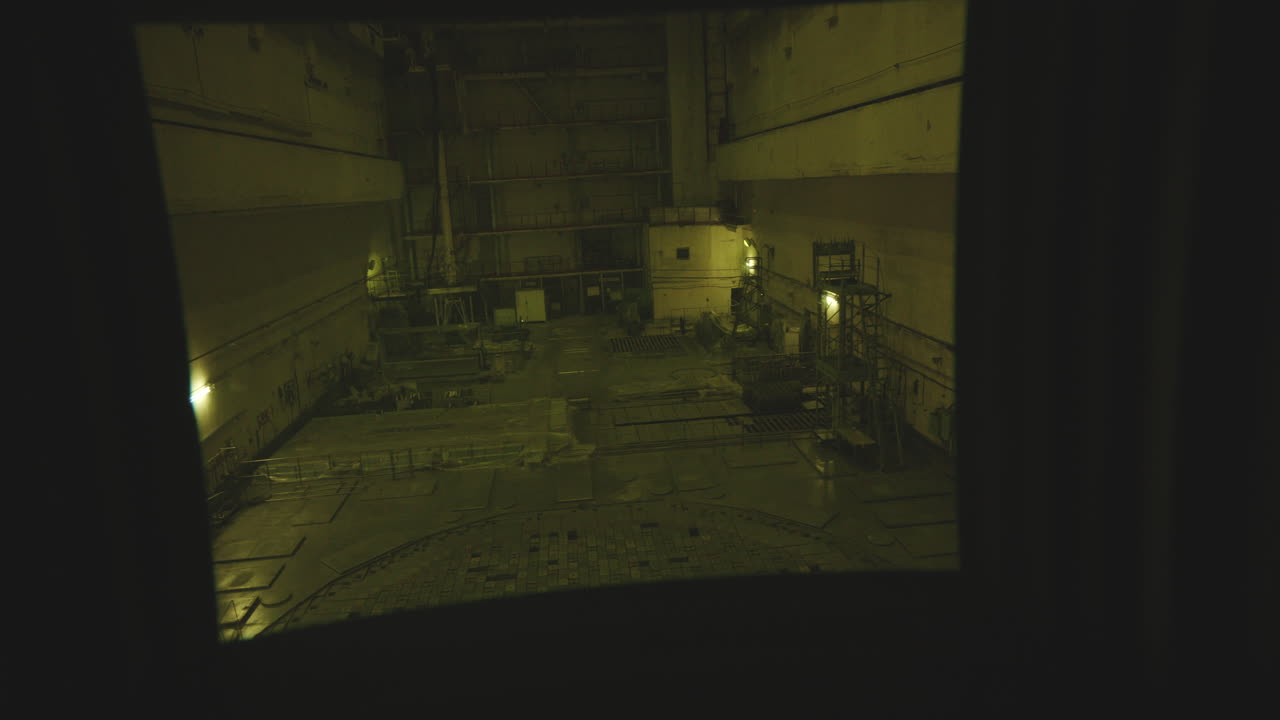 Looking At The Abandoned Facility Of Chernobyl Nuclear Power Plant Through The Window. - handheld shot