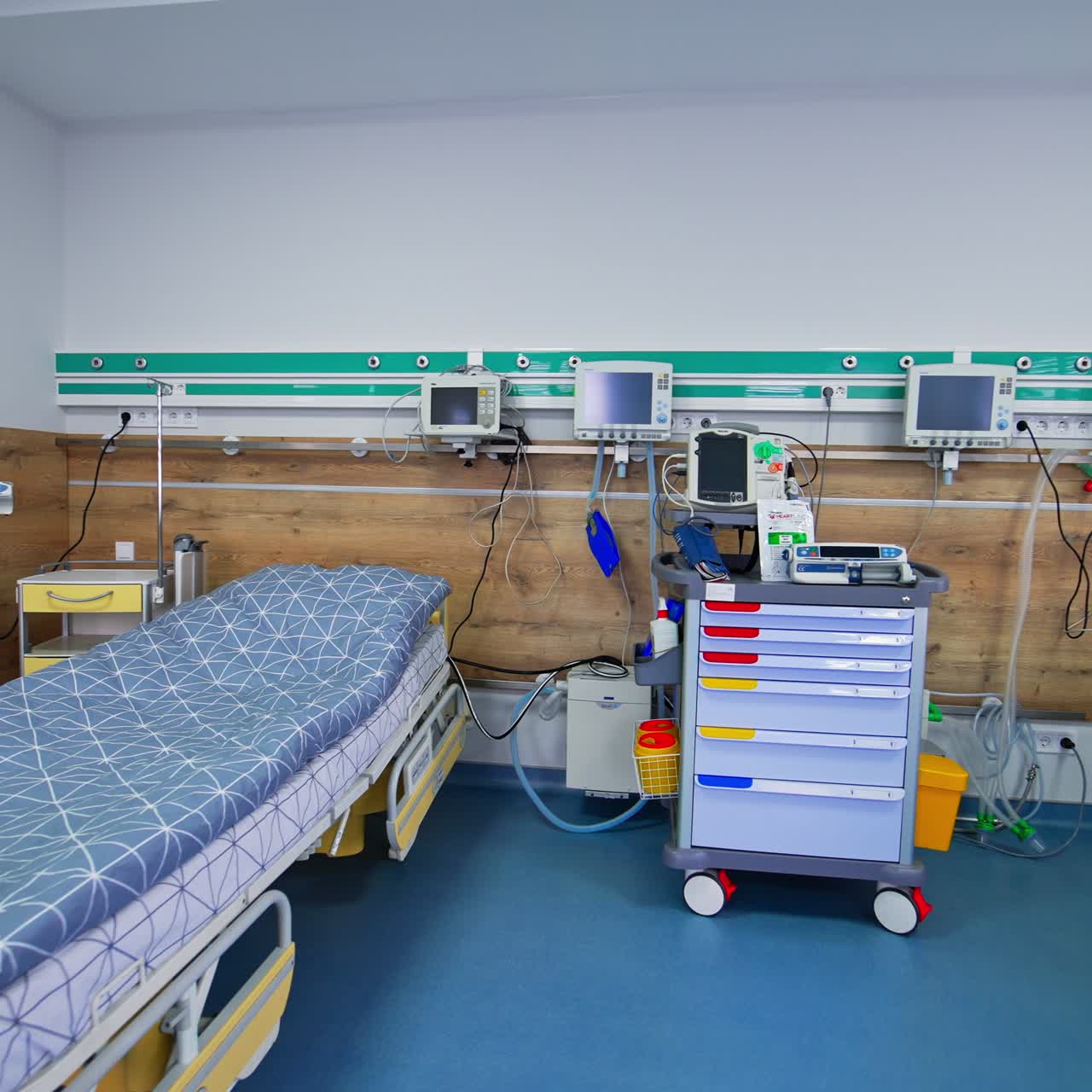 Intensive care unit with two empty wheeled beds. Large ward, fully-equipped and ready for reanimation of the patients
