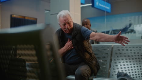man having a medical emergency in an airport