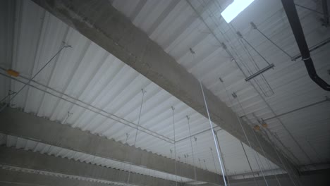 indoor view on a roof steel beam structure in industrial factory. background of factory ceiling with bulbes.