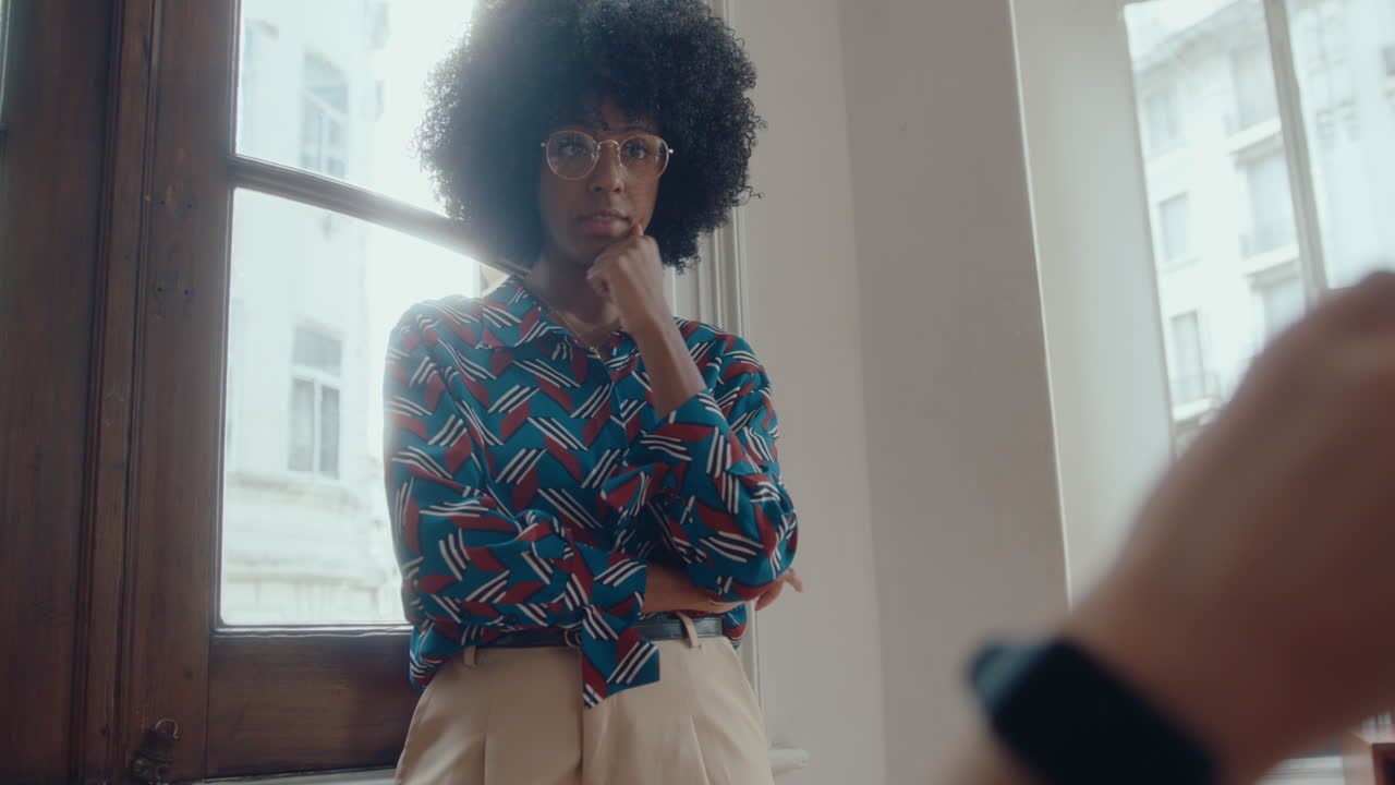 Young Black Businesswoman Having Discussion with Coworker in the Office