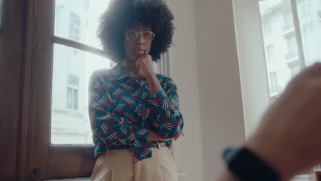 young black businesswoman having discussion with coworker in the office