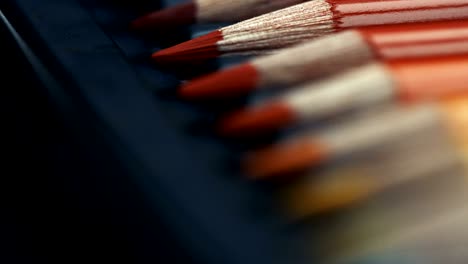 line of different colored pencils in box.sparkling