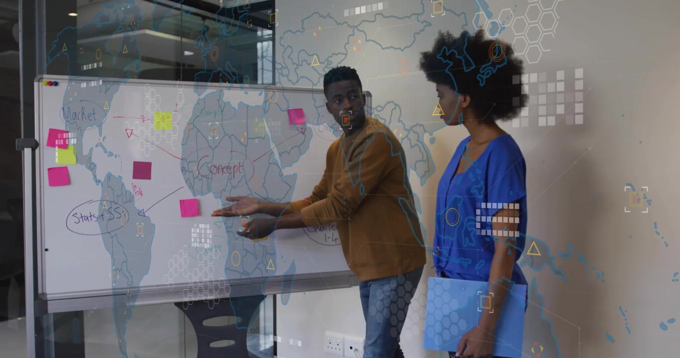 Presenters placing pink note on whiteboard map and causing overlay linking global business strategy