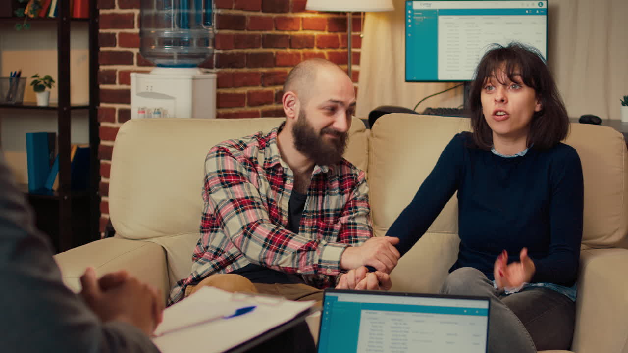 Couple solving marriage problems at counseling session with specialist