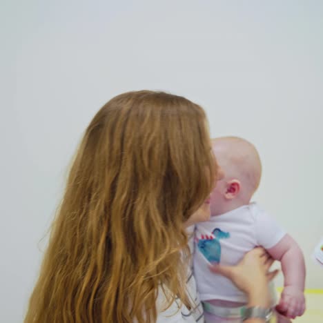 Professional pediatrician examining infant
