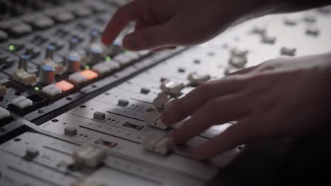 close up shot of professional dj's hands working with a recording board in studio