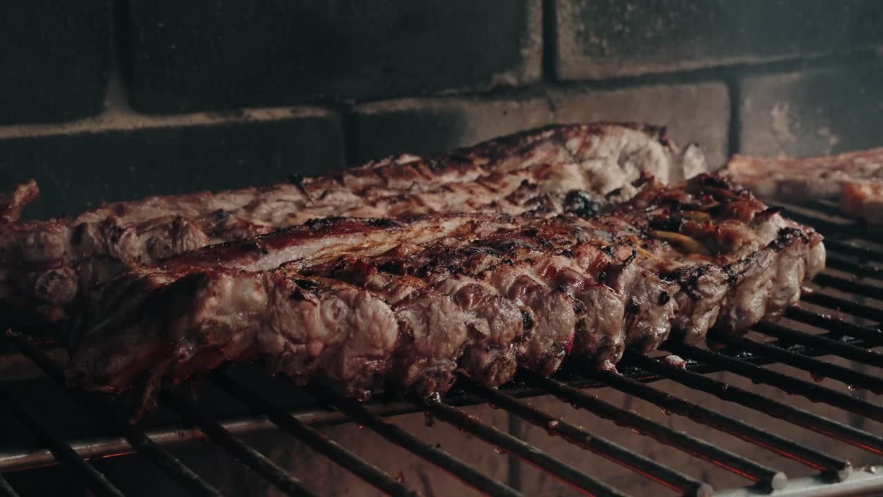slow grilled ribs over hot flames on rustic barbecue with smoky charred texture