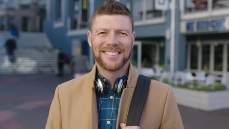 slow motion portrait of charming caucasian man smiling happy in urban background