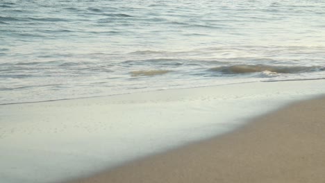 detail of waves at a beach in sunset