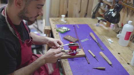 artisan master working on violin bow