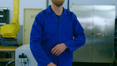 Robotic-engineer-with-arms-crossed-standing-in-warehouse-4k