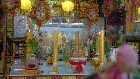 Traditional-Buddhist-shrine-with-candles-and-statues