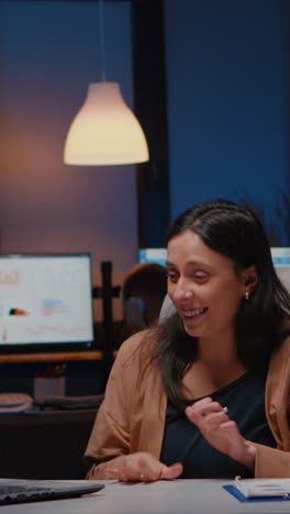 vertical video happy cheerful businesswoman smiling while looking at laptop computer