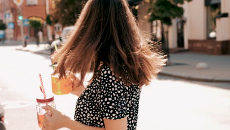 mujer feliz con bebidas en la calle
