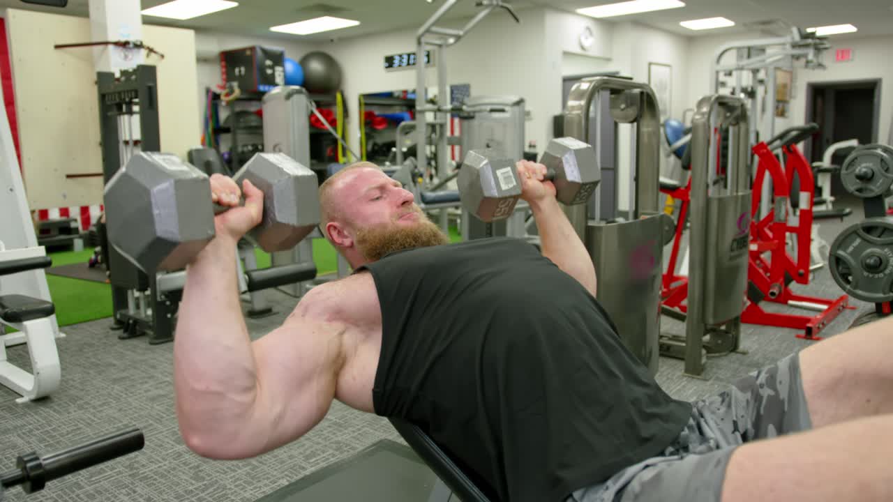 Powerful Man Exercising In Gym