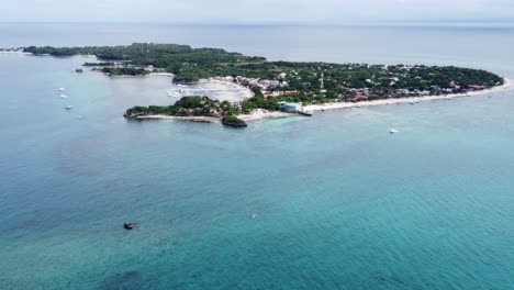 Malapascua-island-far-away-in-the-distance-in-an-aerial-dolly-out-long-shot,-Philippines