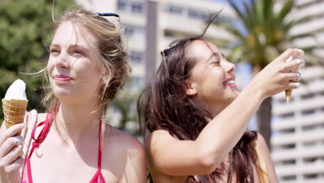 close up portrait teenage girls eating ice cream in the summer on vacation