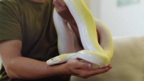 man holding snake indoors