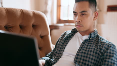 Asian-man,-laptop-or-thinking-on-house-living-room