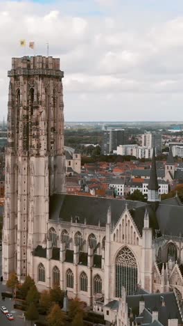 Aerial view of Saint Rumbold's Cathedral in Mechelen, Belgium, showcasing its stunning architecture and dominance over the cityscape. Orbit Motion