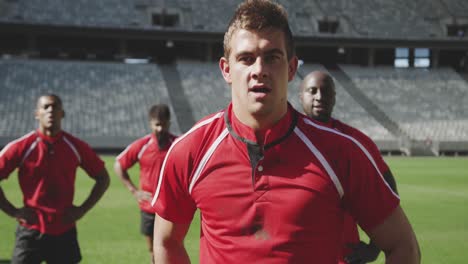 Male-rugby-player-standing-with-hands-on-hip-in-stadium-4k