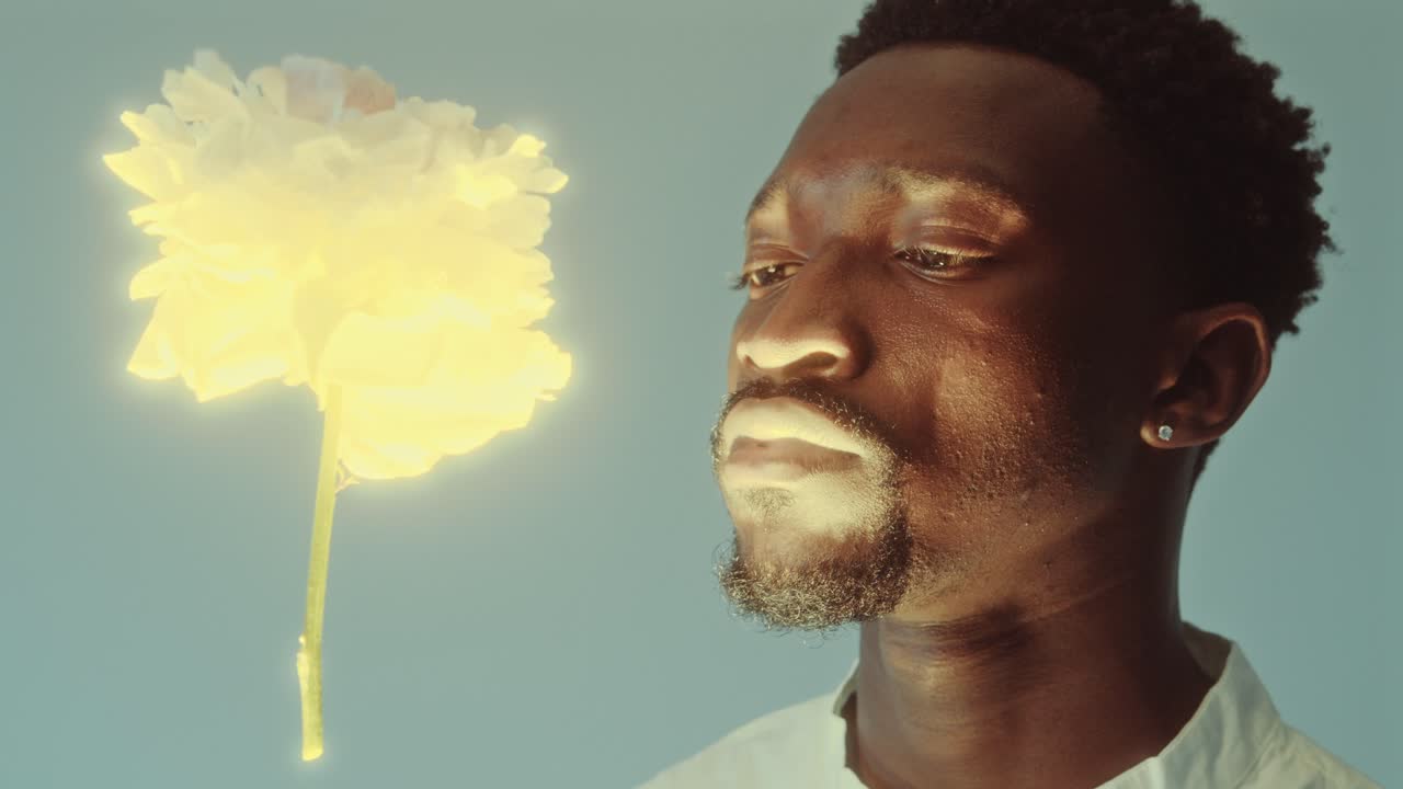 Man Contemplating Glowing Radiant Flower Flying in the Air