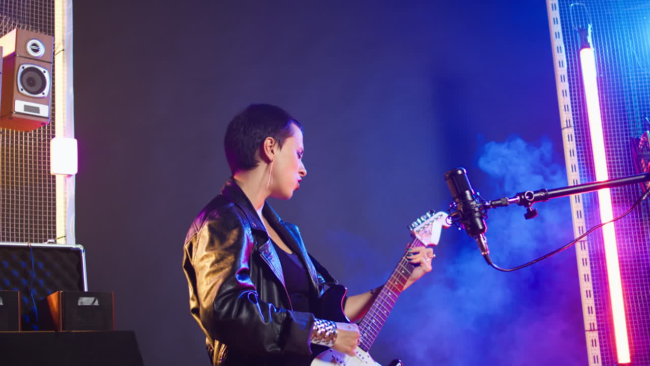 Woman playing electric guitar on stage