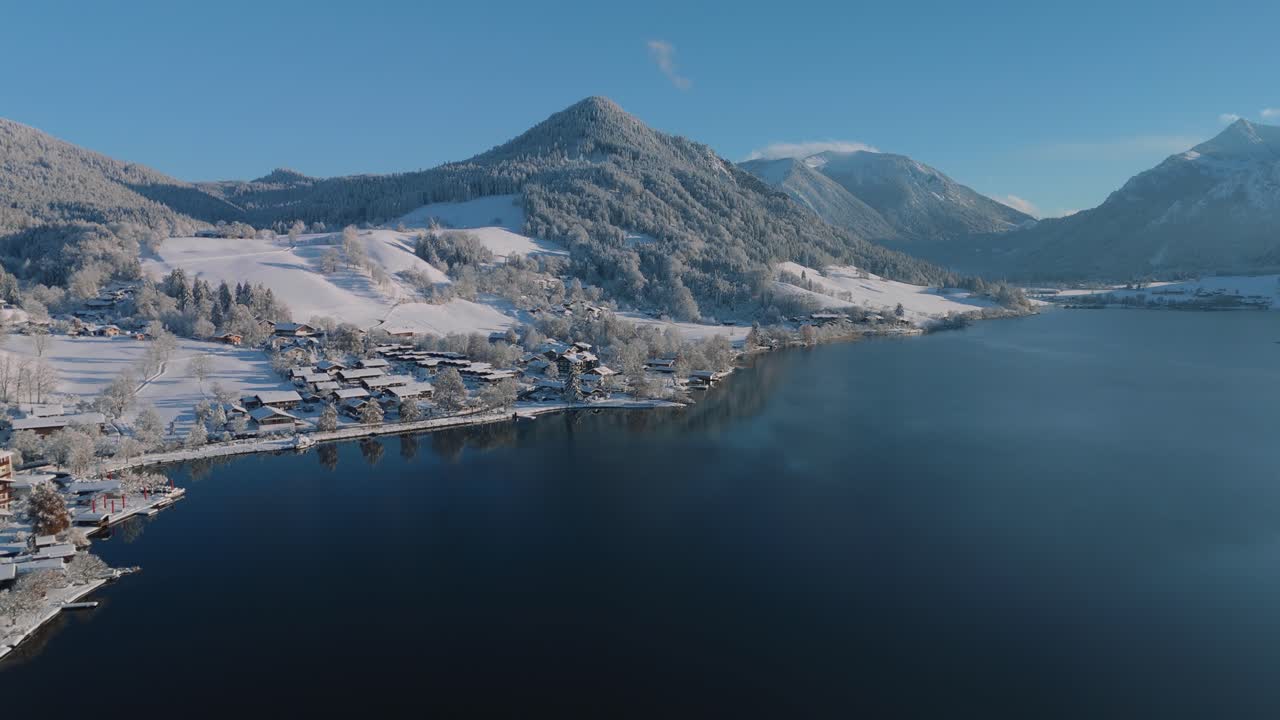 lago schliersee con nieve blanca paisaje de invierno, montañas y agua azul oscuro