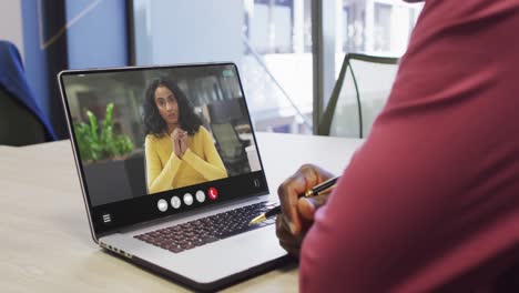 African-american-man-using-laptop-for-video-call,-with-business-colleague-on-screen