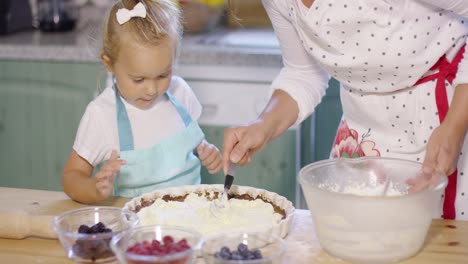 little girl watching the baking with anticipation