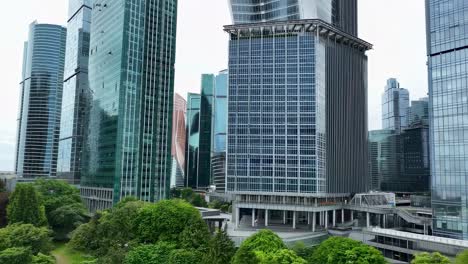 urban metropolis skyline featuring lush green trees bordering modern high rise buildings, revealing harmonious integration of natural environment with contemporary architectural landscape