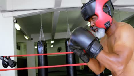 senior man boxing in the fitness studio 4k