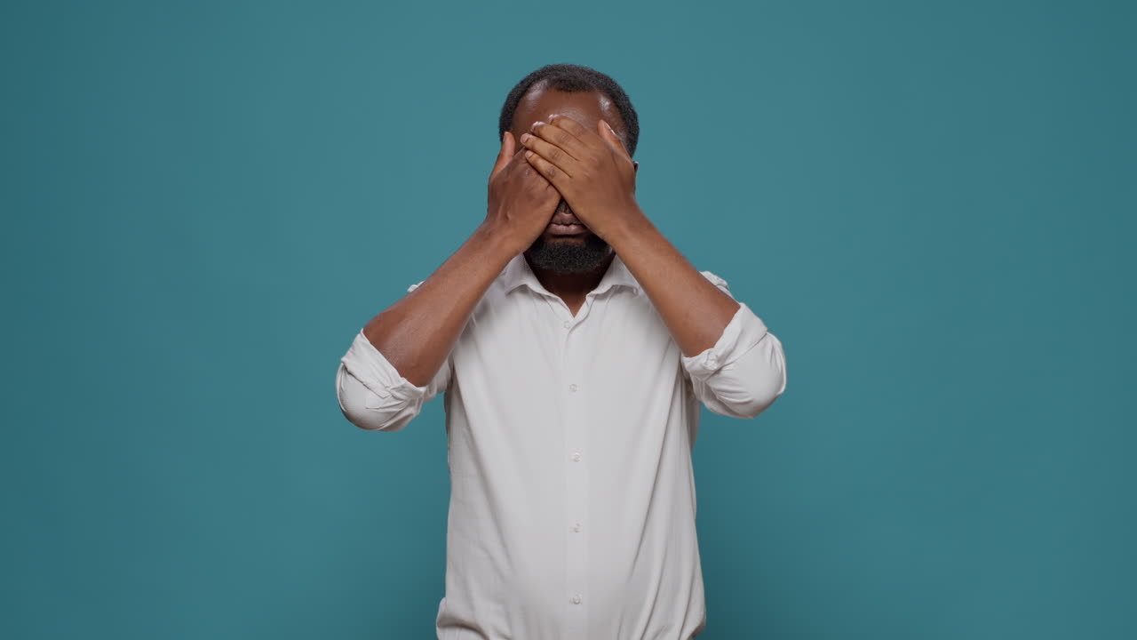 Man covering ears and eyes