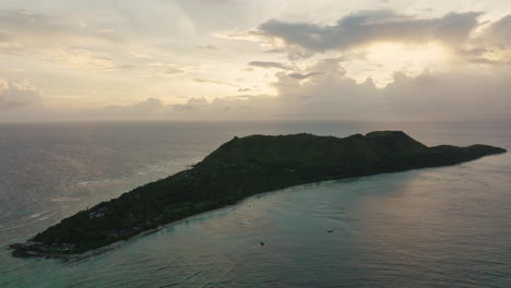 long island in moody light with cloudy sky and calm turquoise water
