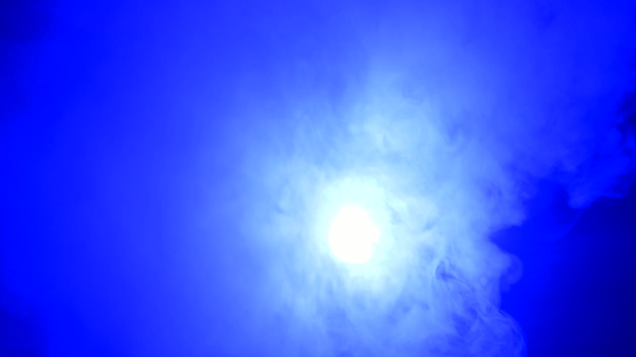 Ambient, abstract, ethereal blue smoke and light motion background for mystical, dreamlike, background atmosphere with calm, serene slow motion fog and moving smoke and light.