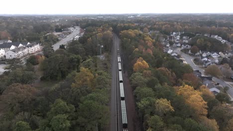 aerial of railway freight car carrying steel pipes and commodities