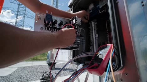 electrical engineers inspect the electrical systems at the equipment control cabinet