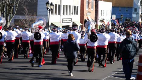 snare drum marching band with tuba players walking away from the camera during the thanksgiving parade 2019 in plymouth massachusetts