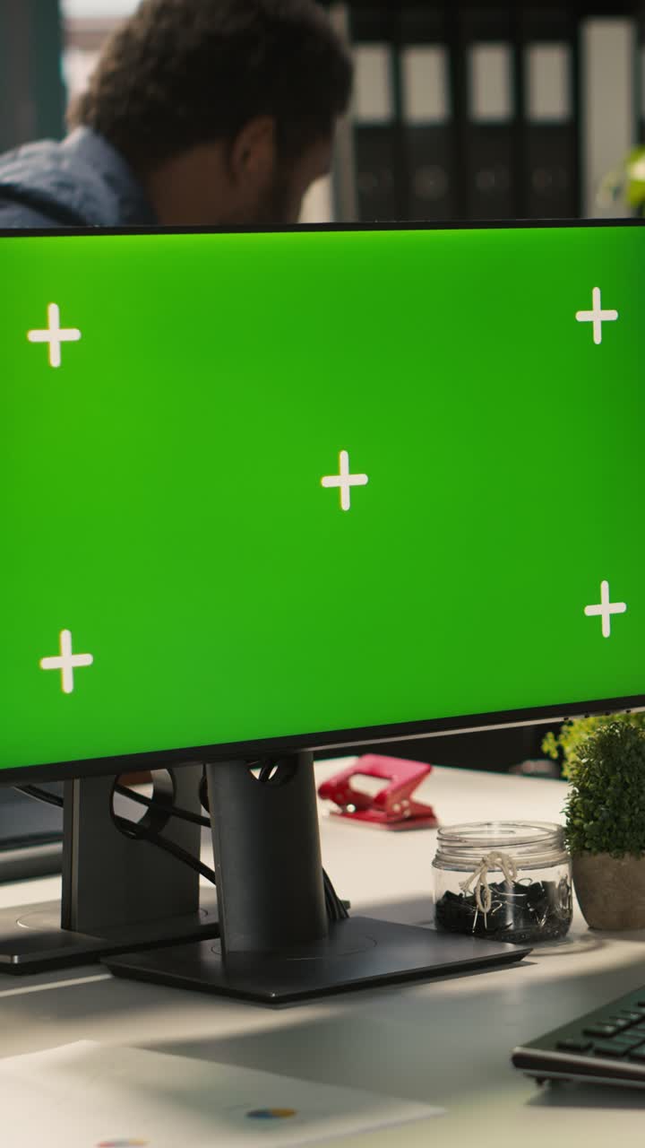 Vertical video Green screen PC in office used by employee working on company tasks