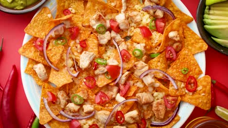 a plate of delicious tortilla nachos with melted cheese sauce  grilled chicken