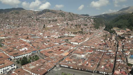 wide revealing aerial shot of cusco, peru during a bright sunny day