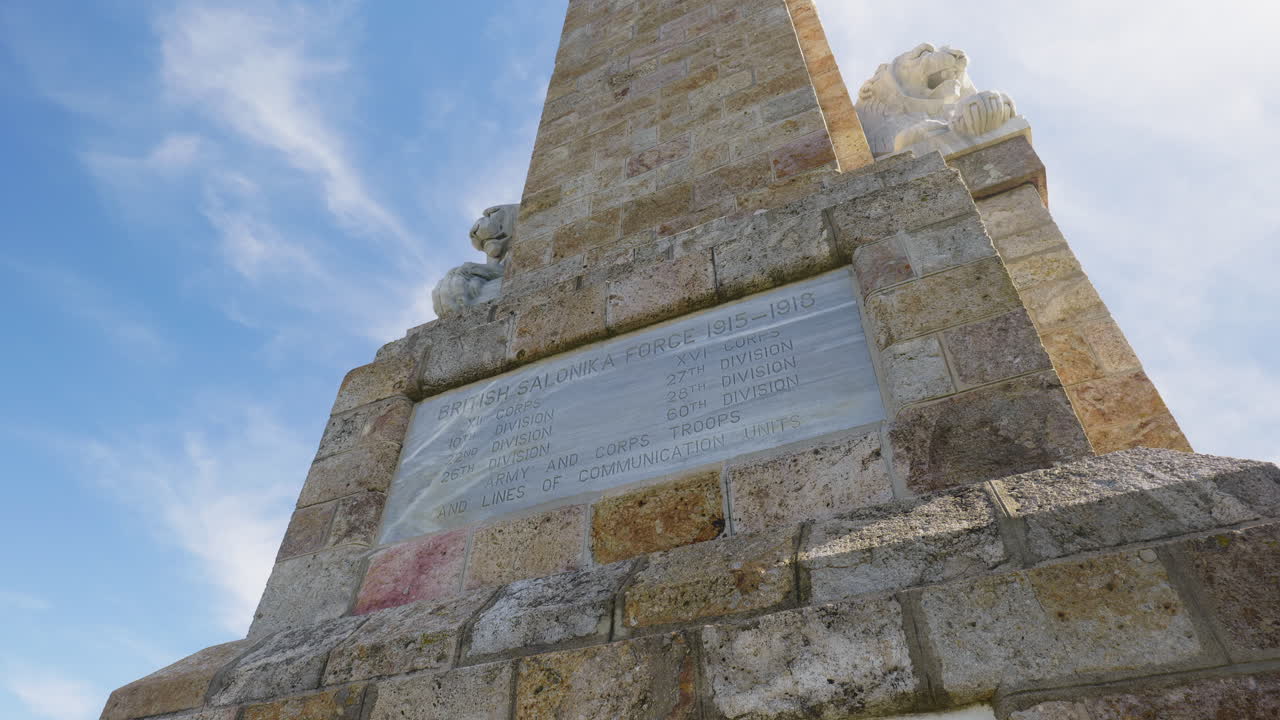 Inquadratura cinematografica in tilt verso l'alto che rivela il Memoriale di Doiran della Prima Guerra Mondiale con sculture di leoni e nomi incisi nel marmo in onore dei soldati britannici e del Commonwealth vicino al confine con la Macedonia.