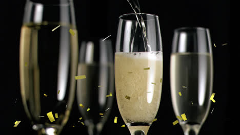 animation of gold confetti falling over chmpagne glasses on black background