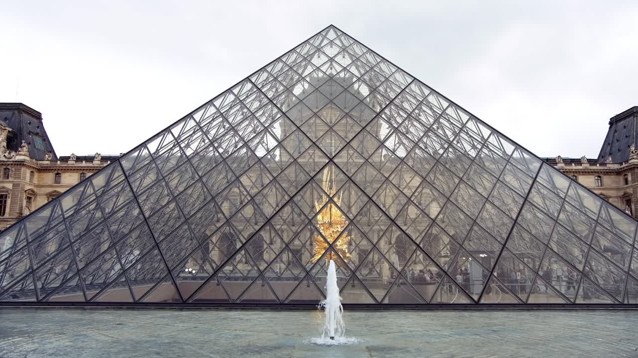 Paris, France - November 21, 2021: Front view of the Louvre Pyramid Museum in daylight