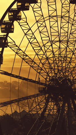 ferris wheel at sunset with vibrant colors reflecting on the water