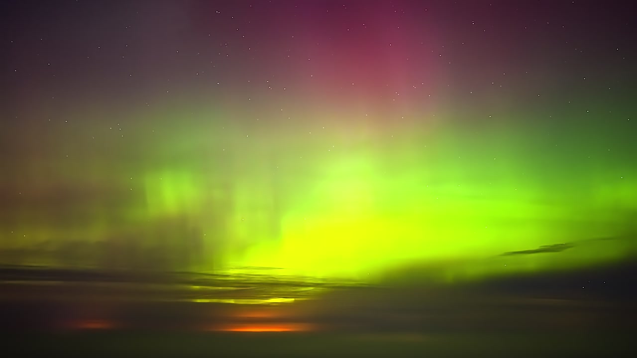 Northern lights timelapse with green aurora in night sky