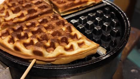 deliciously golden brown waffles on a waffle iron